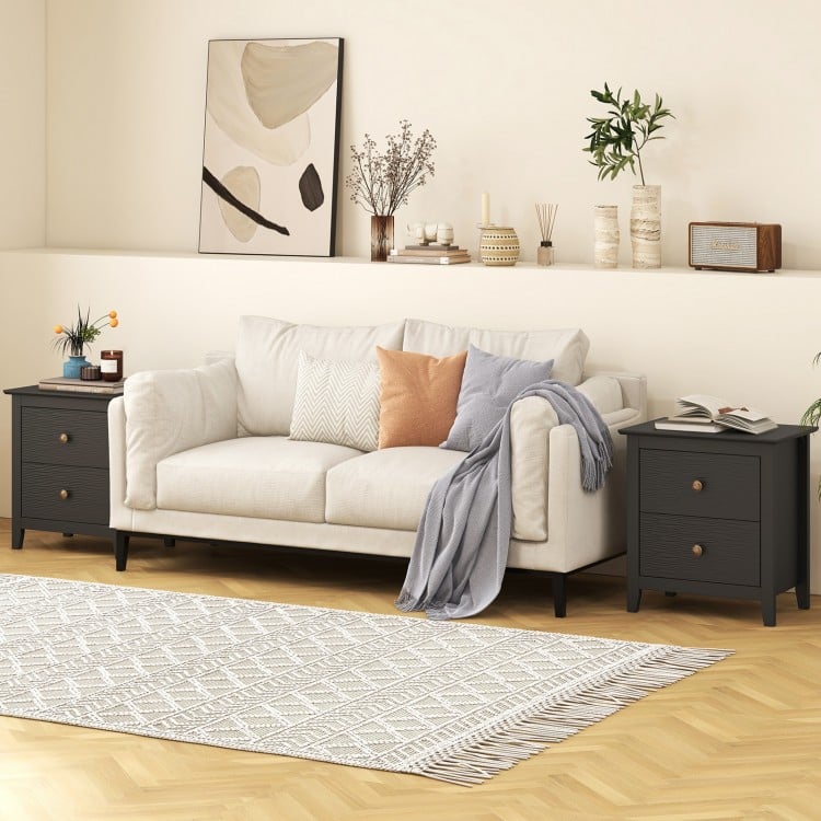Black modern nightstand with two drawers, featuring a wide tabletop, ideal for small spaces in bedrooms or living rooms.