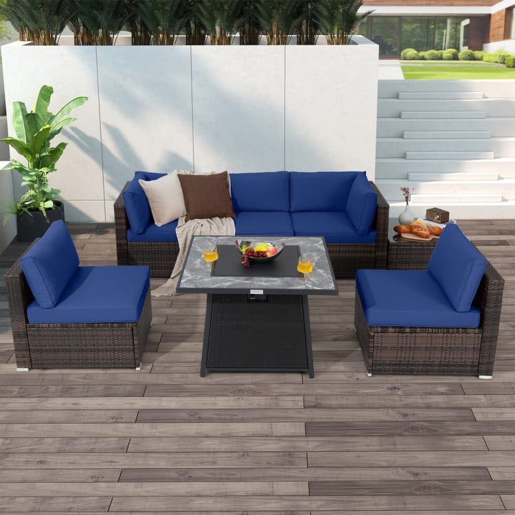 7-piece patio furniture set featuring navy cushions and a 35-inch propane gas fire pit table for outdoor relaxation.
