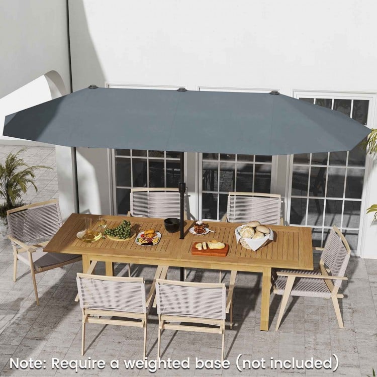 Double-sided 13 ft gray patio umbrella with crank handle, ideal for providing shade on patios and outdoor gatherings.