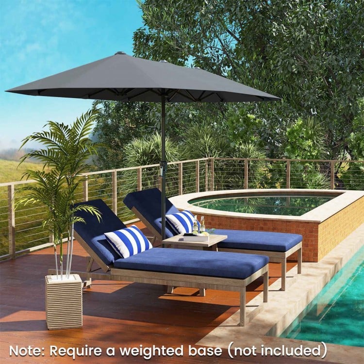 Double-sided 13 ft gray patio umbrella with crank handle, providing ample shade for poolside relaxation.