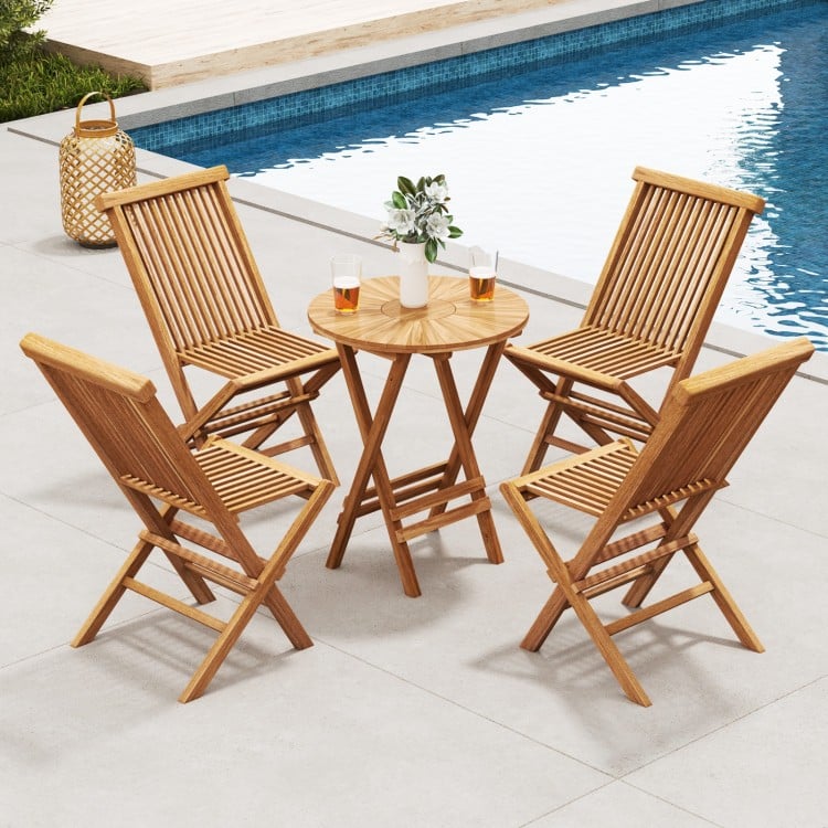 Set of two outdoor teak wood chairs with slatted seats, arranged around a round table by the pool for relaxation.