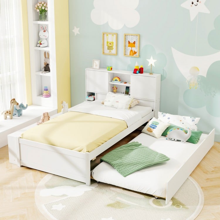 Twin size bed frame with trundle in white, featuring a storage headboard and power outlets for convenient charging.