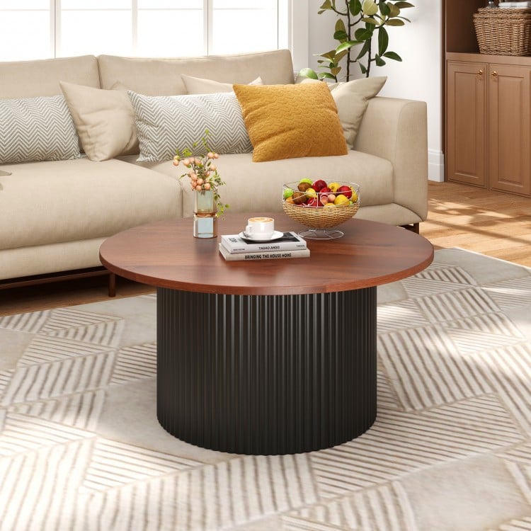 Round coffee table with walnut wooden top and wave-shaped support, ideal for versatile room settings and ample storage.