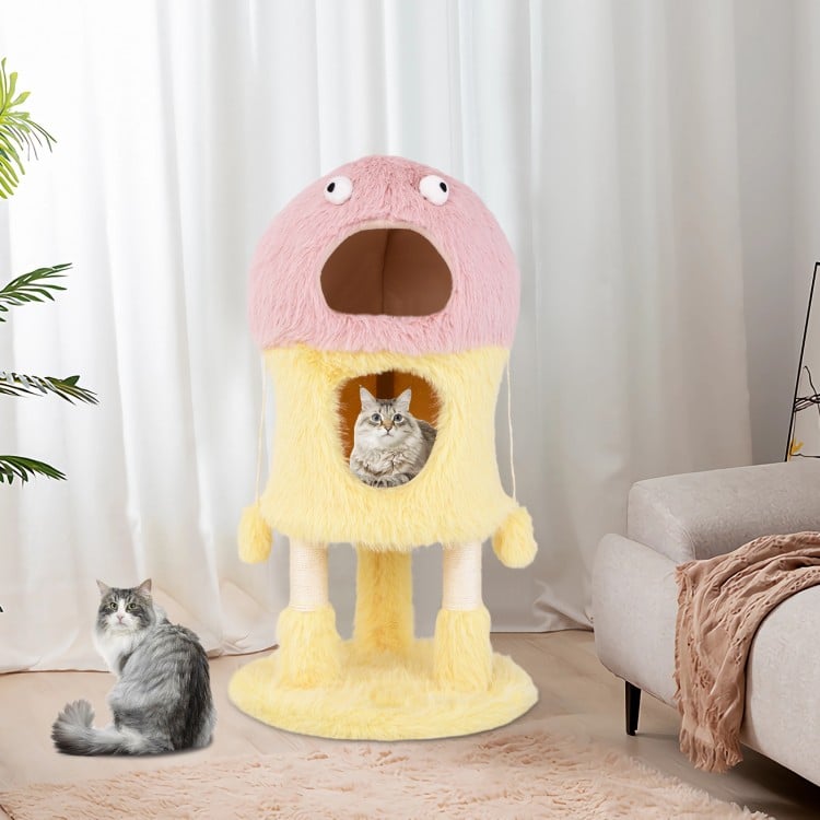 Cute monster-themed cat tower in yellow with two condos, plush fabric, and hanging toys for playful cats.