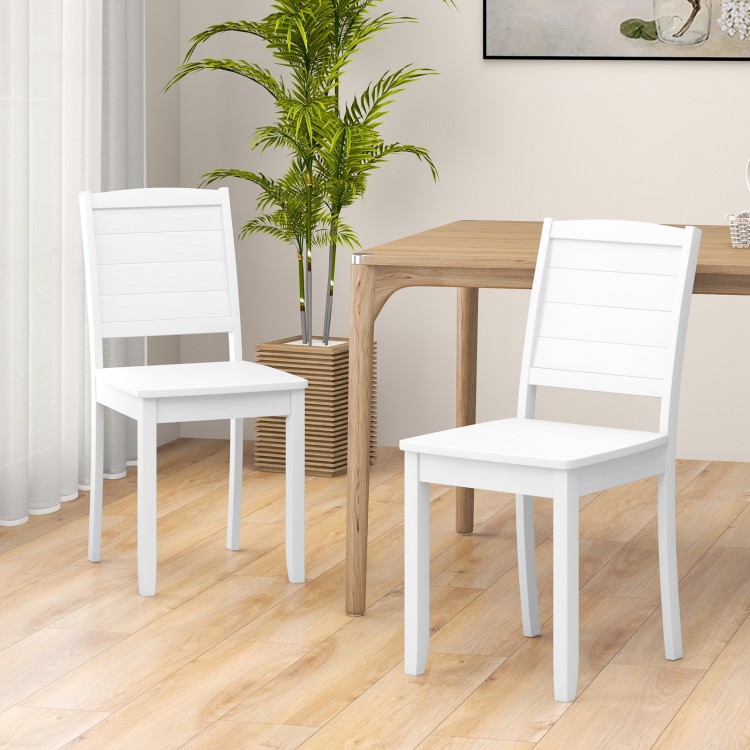 White wood dining chair set of 2 with rubber wood legs, featuring a curved backrest for comfort in a rustic kitchen.