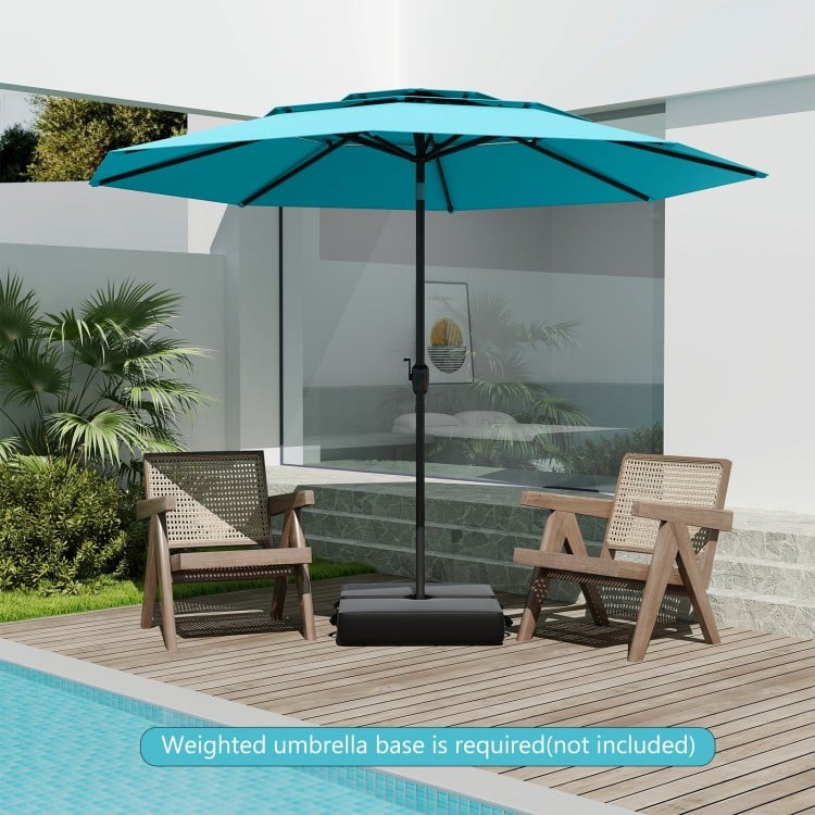10 ft 3-tier vented patio umbrella in green with push button tilt, placed beside two chairs by the poolside.