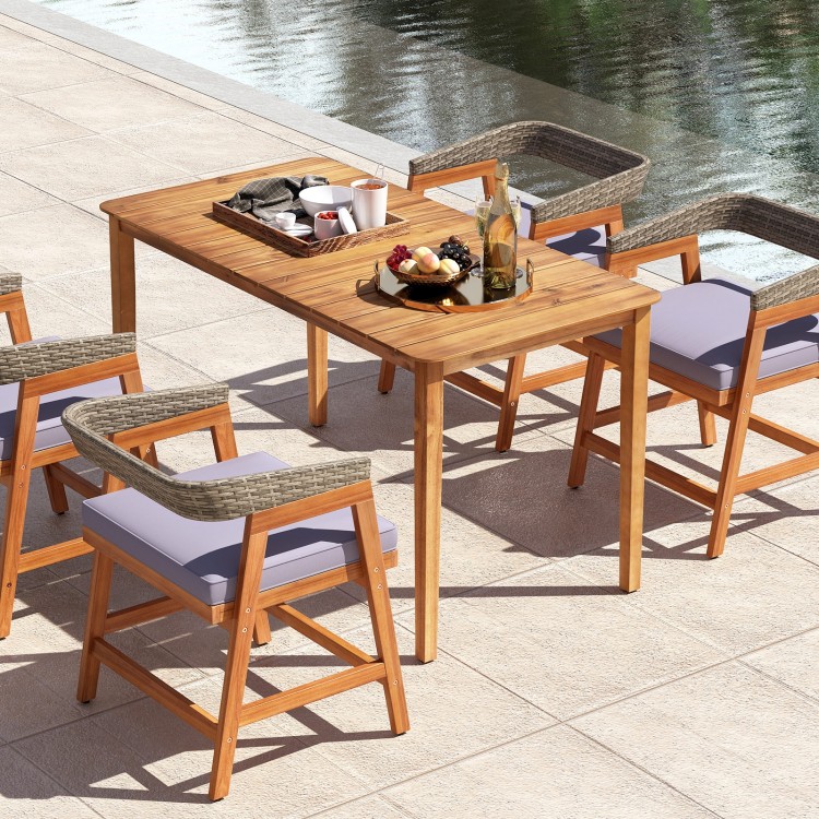Rectangular outdoor dining table made of acacia wood, seating 4-6 people, with slatted tabletop for easy cleaning.