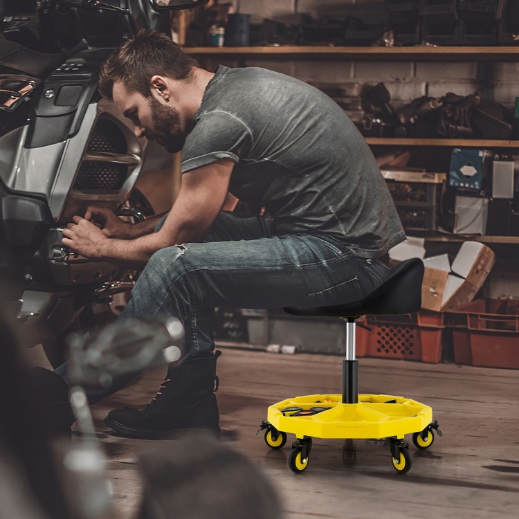 Height adjustable yellow rolling garage stool with tool tray storage, featuring a padded seat and 5 wheels for easy.