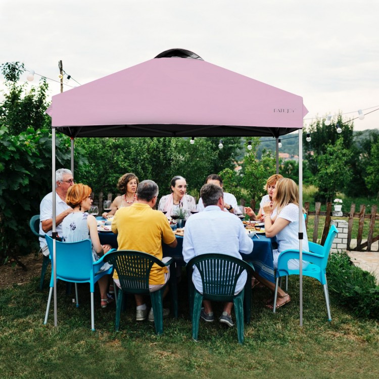 Outdoor pop-up canopy tent in pink, 6.6' x 6.6', height adjustable, providing shade for gatherings in outdoor settings.