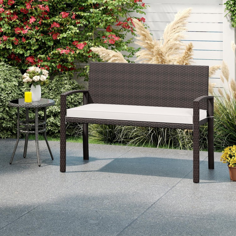 Wicker 2-seat bench with soft cushion and metal frame, ideal for outdoor patios and gardens, featuring cozy backrests.