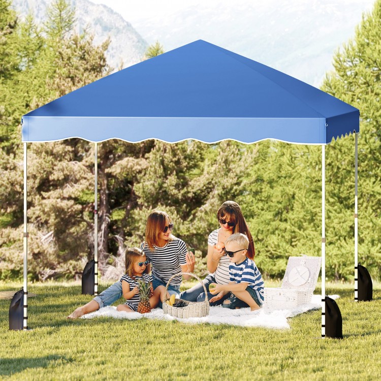 Foldable 10x10 feet blue pop-up canopy tent set up for a picnic, offering UPF50+ sun protection and easy transport.