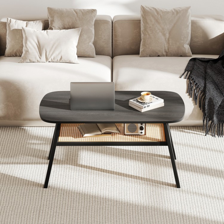 Rectangular coffee table with dark gray wood-grain surface, rattan storage shelf, and rubber wood legs for stylish.
