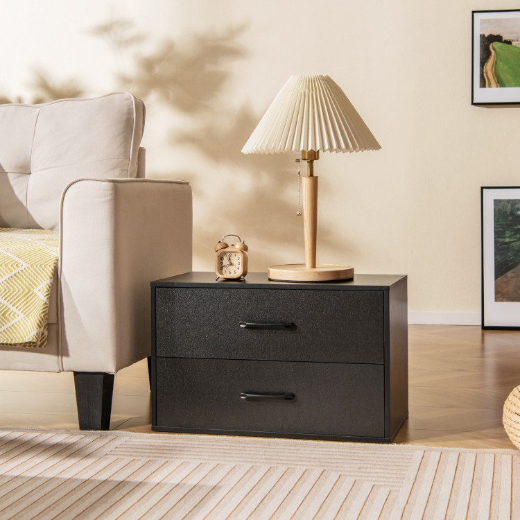 Black 2-drawer storage cabinet with handles, ideal for office supplies, placed beside a lamp and sofa in a living room.