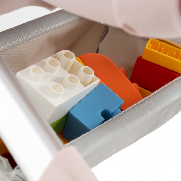 Colorful building blocks in the storage basket of a pink 2-in-1 kids ride-on push car for indoor and outdoor play.