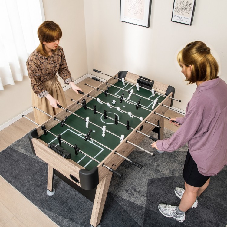 Two players enjoying a 54-inch foosball table made of premium MDF, featuring 26 players and adjustable leg levelers.