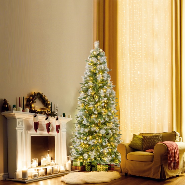 Pencil-shaped 6 FT artificial Christmas tree with warm-white LED lights, set by a cozy fireplace for festive decor.
