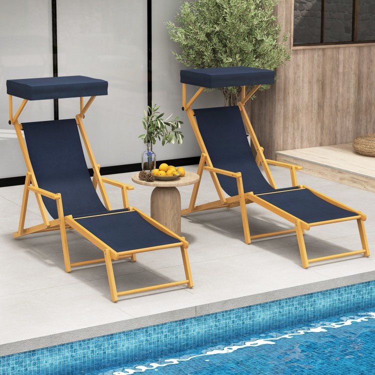 Two navy birch wood chaise lounge chairs with adjustable canopies, perfect for poolside relaxation and outdoor.