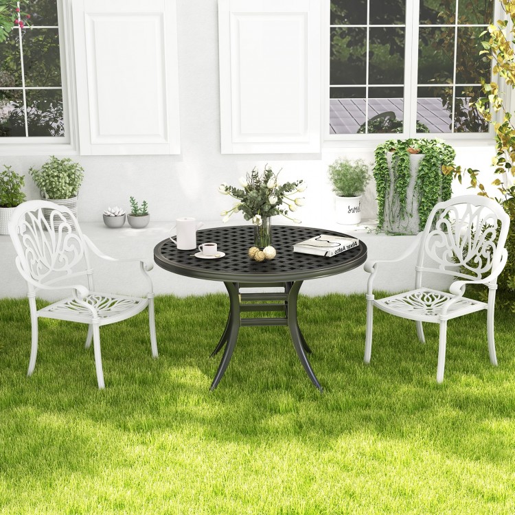 White cast aluminum dining chairs with armrests, stackable design, perfect for outdoor patio or garden use.