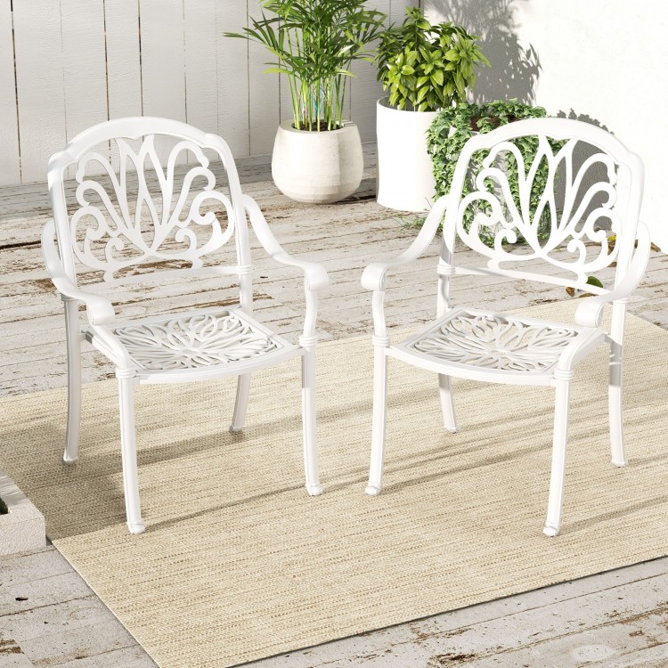 White cast aluminum dining chairs with armrests, stackable design, ideal for outdoor spaces like porches and gardens.
