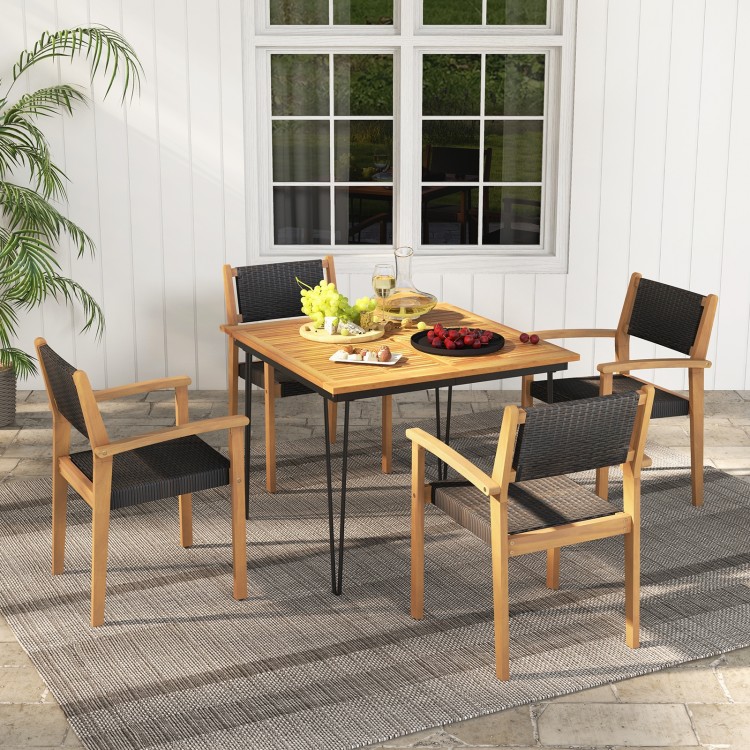 Stackable outdoor wicker dining chairs with acacia wood frame and ergonomic backrest, perfect for backyard dining.