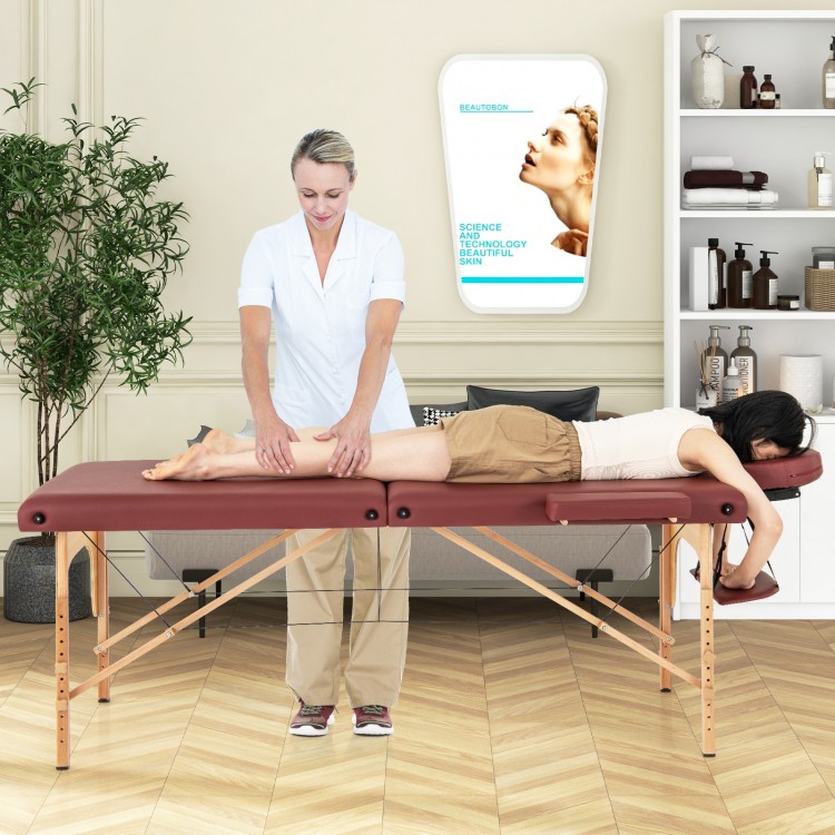 Foldable 84-inch massage table in red with adjustable headrest, side armrests, and carrying bag for easy transport.