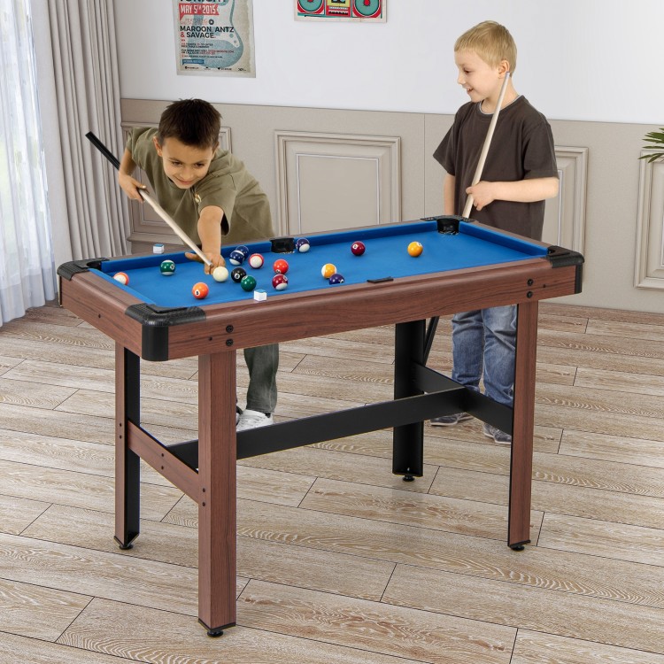 Kids playing on a 48-inch blue pool table with wooden frame, featuring a full set of balls for family fun.