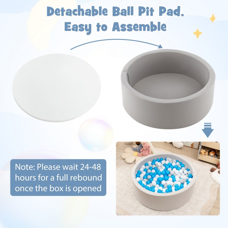 Soft gray kiddie ball pit with detachable pad and 200 BPA-free ocean balls, perfect for kids' playtime in any room.