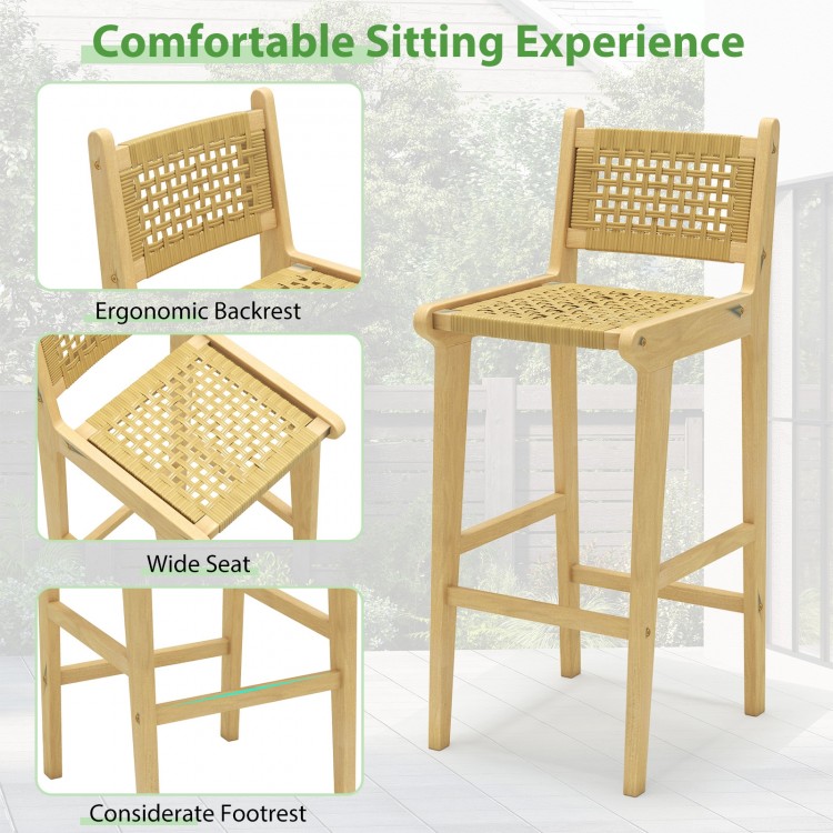 Teak wood bar stool with rattan backrest and wide seat, featuring ergonomic design and footrest for outdoor comfort.