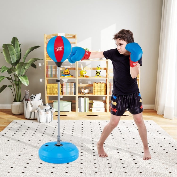 Adjustable punching bag with stand and blue boxing gloves, designed for kids and adults, enhancing hand-eye.