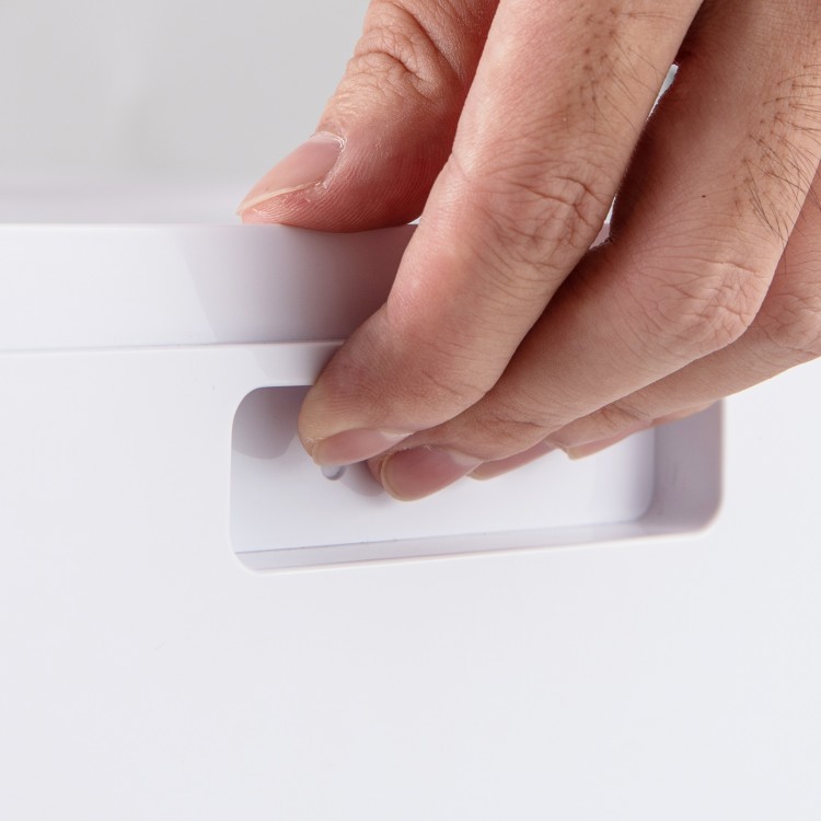 Close-up of the 4-in-1 portable air conditioner's control panel with a hand adjusting the settings for optimal cooling.
