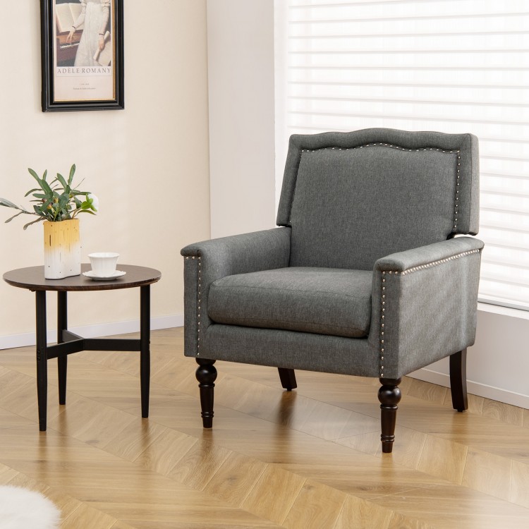 Gray mid-century modern armchair with cushion and nailhead trim, perfect for living rooms or bedrooms.