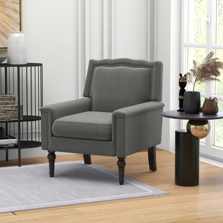 Mid-century modern armchair in gray linen fabric with cushion, featuring nailhead trim and robust rubber wood legs.