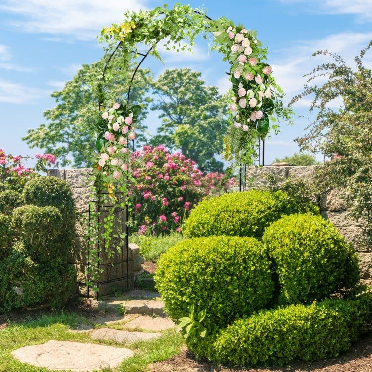 Metal garden arch backdrop stand with climbing plant trellis, featuring an elegant arched design for outdoor.