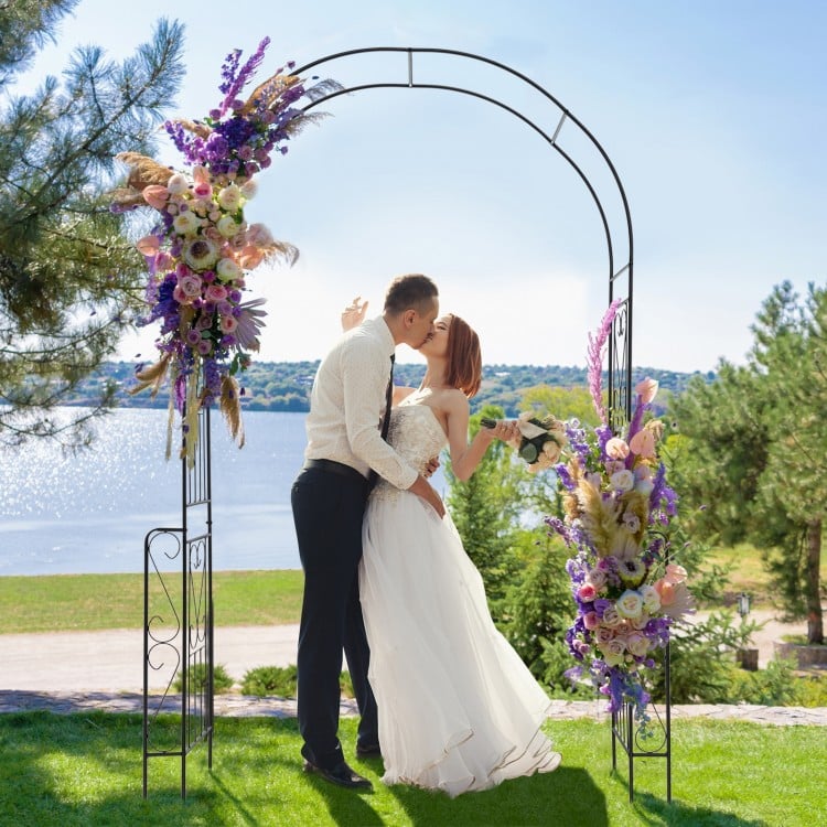 Metal garden arch backdrop stand with floral decorations, perfect for weddings and climbing plants in outdoor settings.