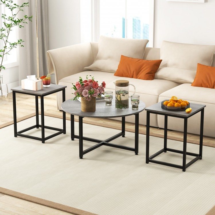 Round coffee table with two square end tables in gray, featuring a textured surface and sturdy metal frame for.