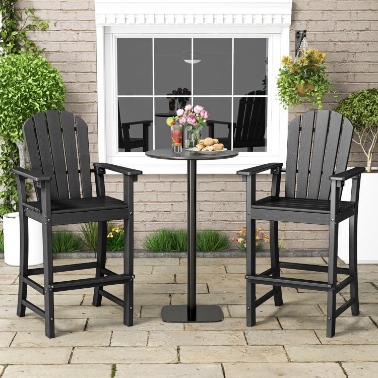 Set of 2 black HDPE counter height bar stools with armrests and footrest, perfect for outdoor use.