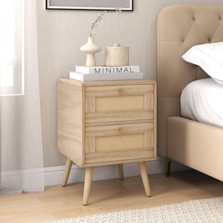 Natural rattan nightstand with two storage drawers, featuring a smooth wood grain surface and sturdy legs for bedside.