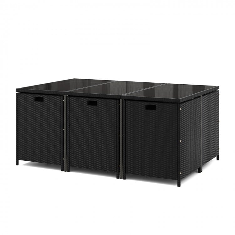 Black wicker dining table with tempered glass top, featuring a space-saving design for outdoor patio use.