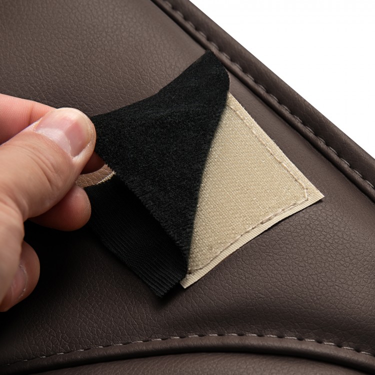 Close-up of the brown massage chair backrest cushion showing the hook and loop fastener for easy attachment.