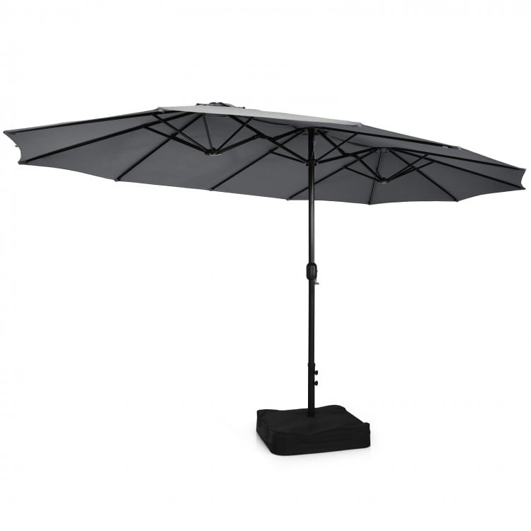 Double-sided gray patio umbrella with a sturdy base, designed for outdoor dining sets and family gatherings.