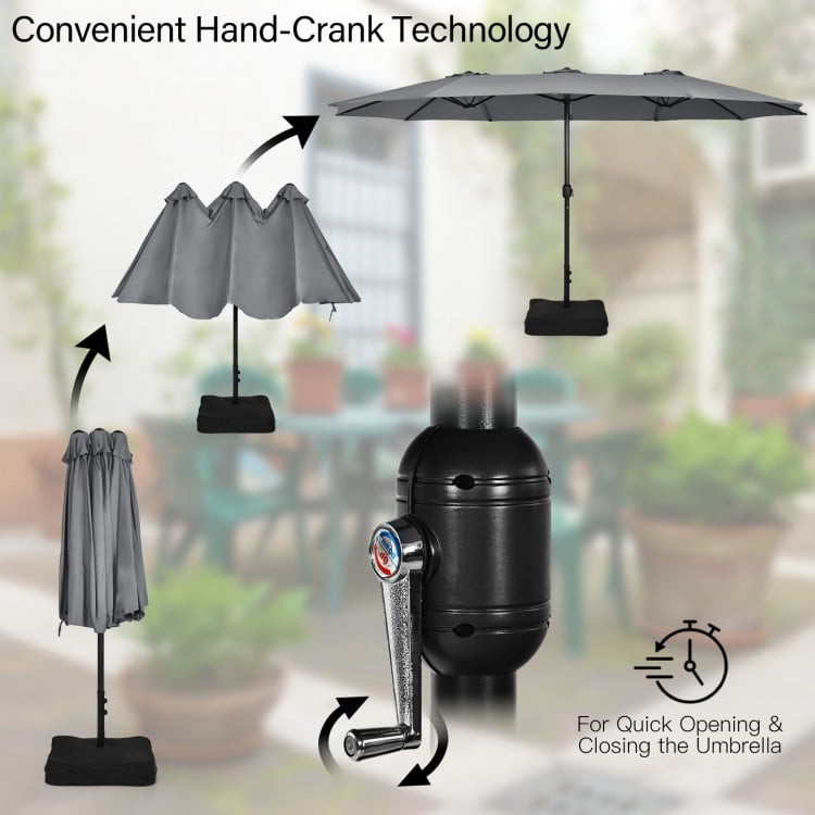 Gray double-sided patio umbrella with hand-crank technology, ideal for outdoor dining and relaxation.