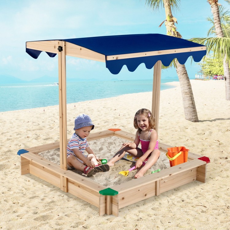 Kids wooden sandbox with adjustable blue canopy, perfect for outdoor play for 2-4 children on the beach.