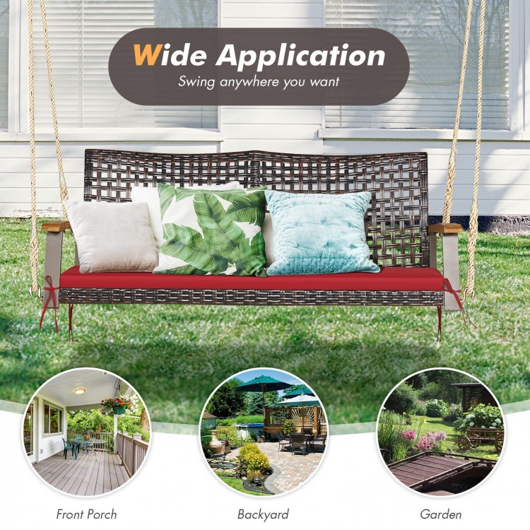 2-person rattan hanging porch swing chair in red with acacia wood armrests, ideal for backyard or garden relaxation.