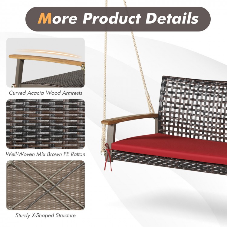 Curved acacia wood armrests and red cushion detail of the 2-person rattan hanging porch swing chair for outdoor.
