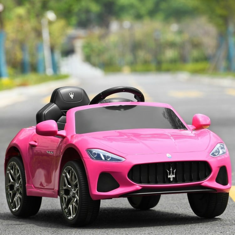 Front view of the pink 12V Maserati kids ride-on car with sleek design, stylish wheels, and fun LED lights for outdoor.