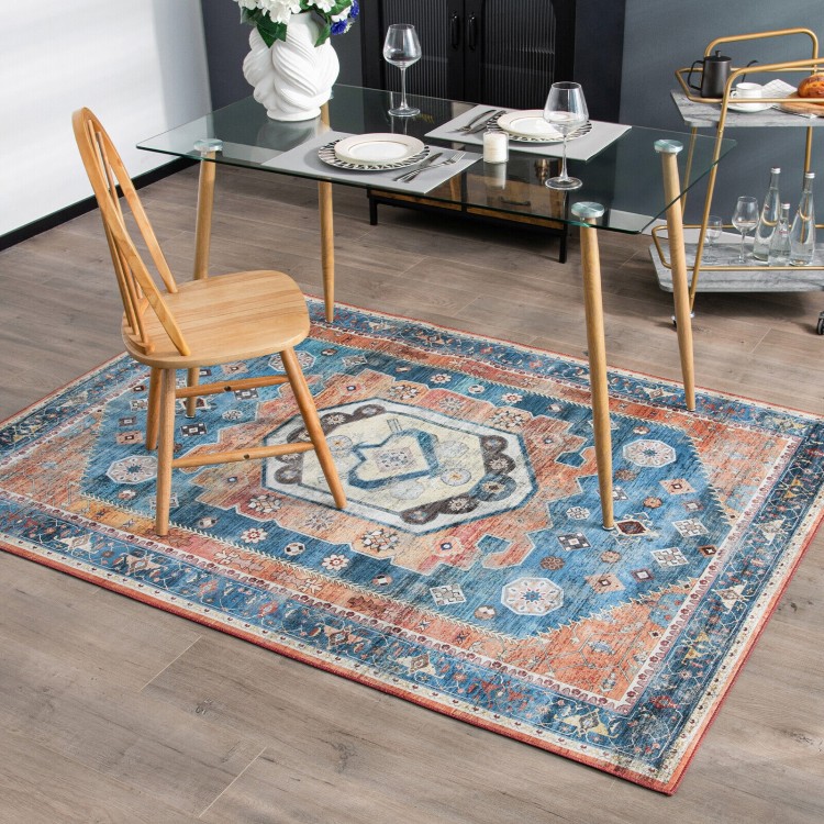 Distressed vintage 5 x 7 inch area rug with intricate pattern and colors, ideal for living room or dining room use.