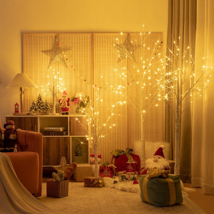 Pre-lit 4 ft white twig birch tree with 48 LED lights, creating a warm festive atmosphere for holiday indoor decoration.