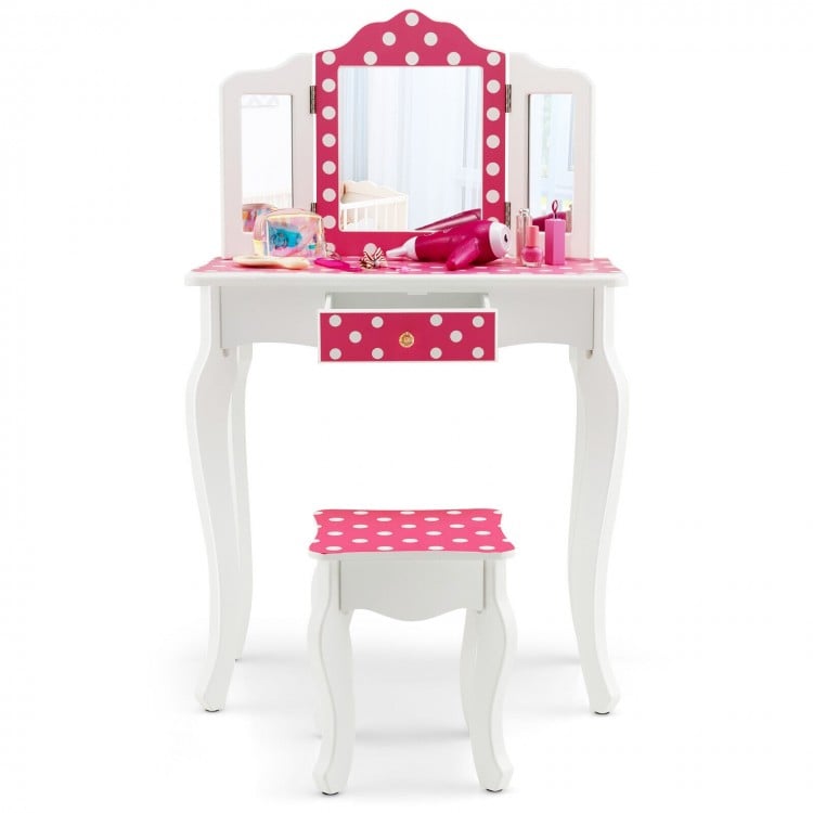 Kids vanity table and stool set in pink with polka dot print, featuring a tri-folding mirror and ample storage space.