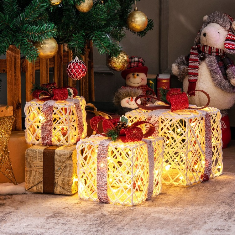 Set of 3 lighted Christmas gift boxes with red bows, featuring warm-white LED lights for festive outdoor decoration.