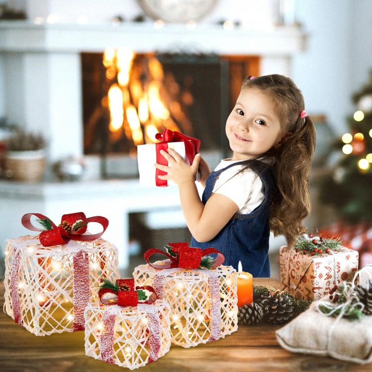 Set of 3 lighted Christmas gift boxes with red bows, covered in snow, perfect for festive home decoration.